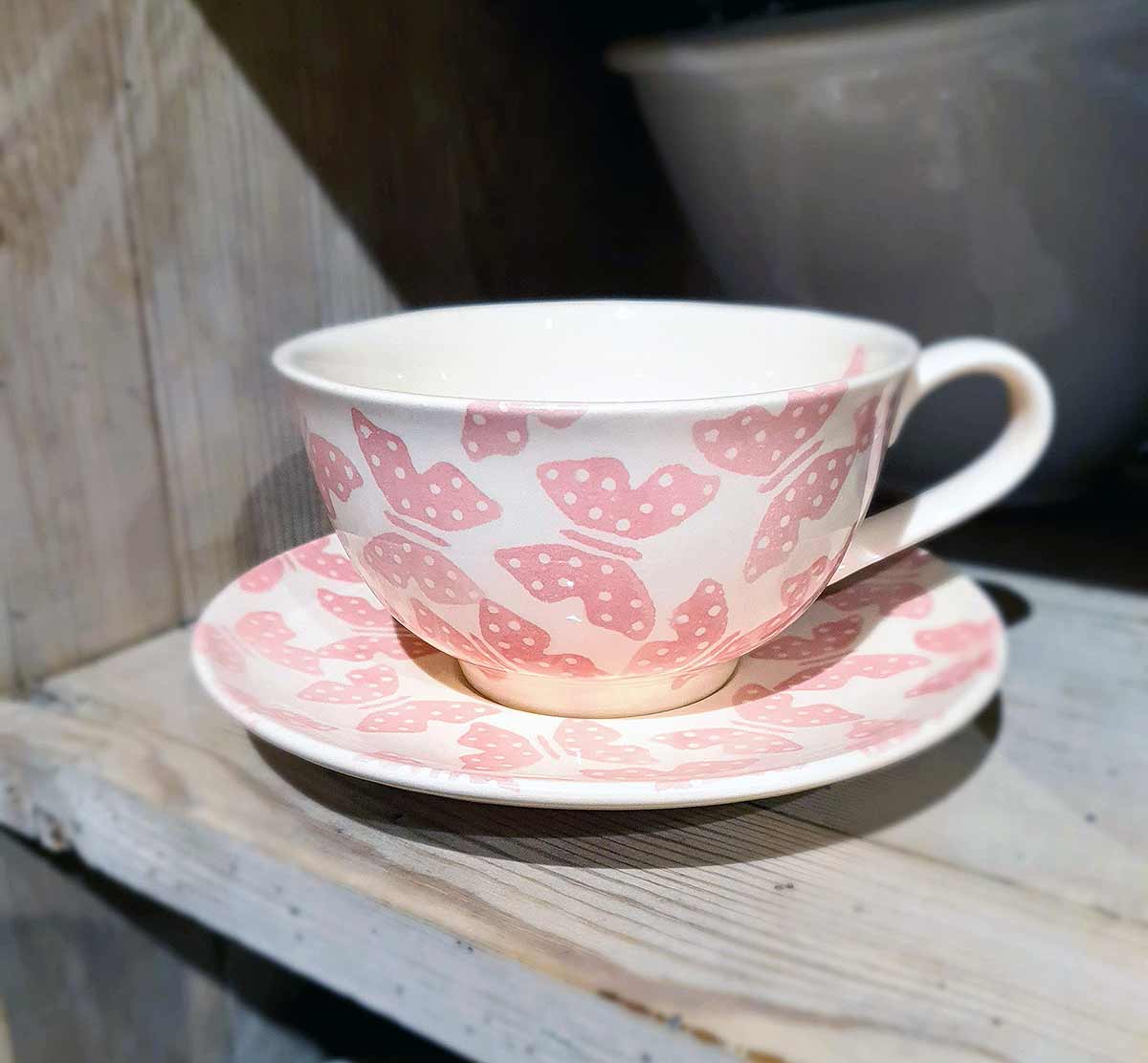 cup and saucer on shelf