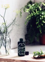 open bottle on wood shelf over bath