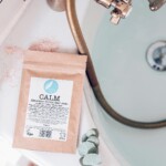 bath salts sachet spilling salts on edge of full bath