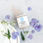 powder box on table with flower petals