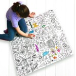 girl sitting on floor colouring tablecloth