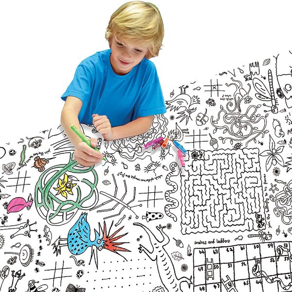 boy sitting at table colouring tablecloth