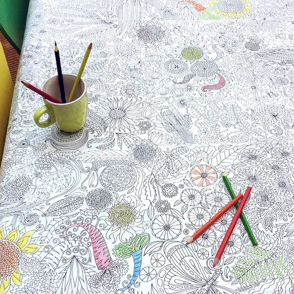 tablecloth partially coloured in with crayons in mug