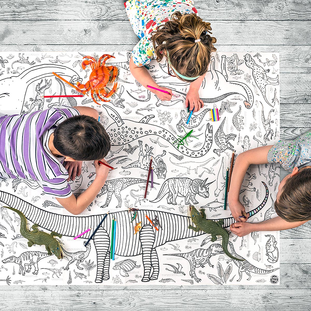 children lying on floor colouring tablecloth