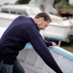 fisherman in boat wearing jumper