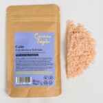 sachet with loose salts on plain background