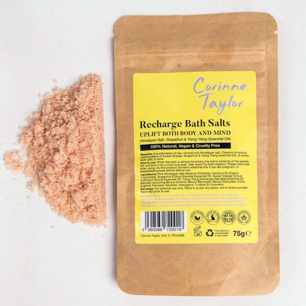 sachet and loose salts on plain background
