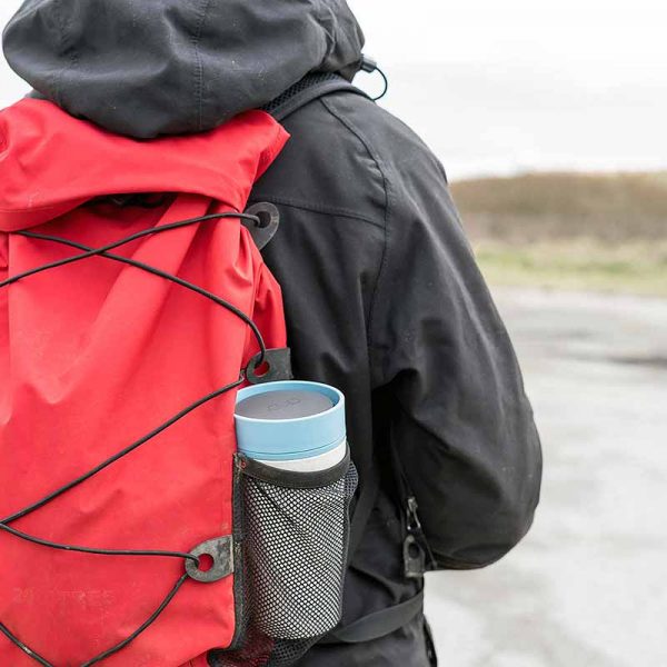 cup in rucksack on man's back