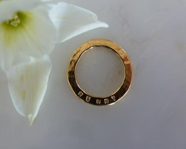 gold ring disc on white surface