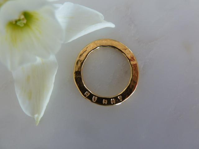 gold ring disc on white surface