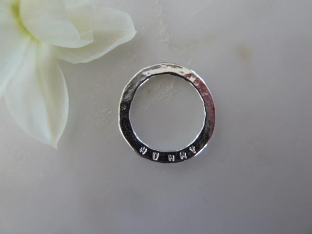 silver ring disc on white surface