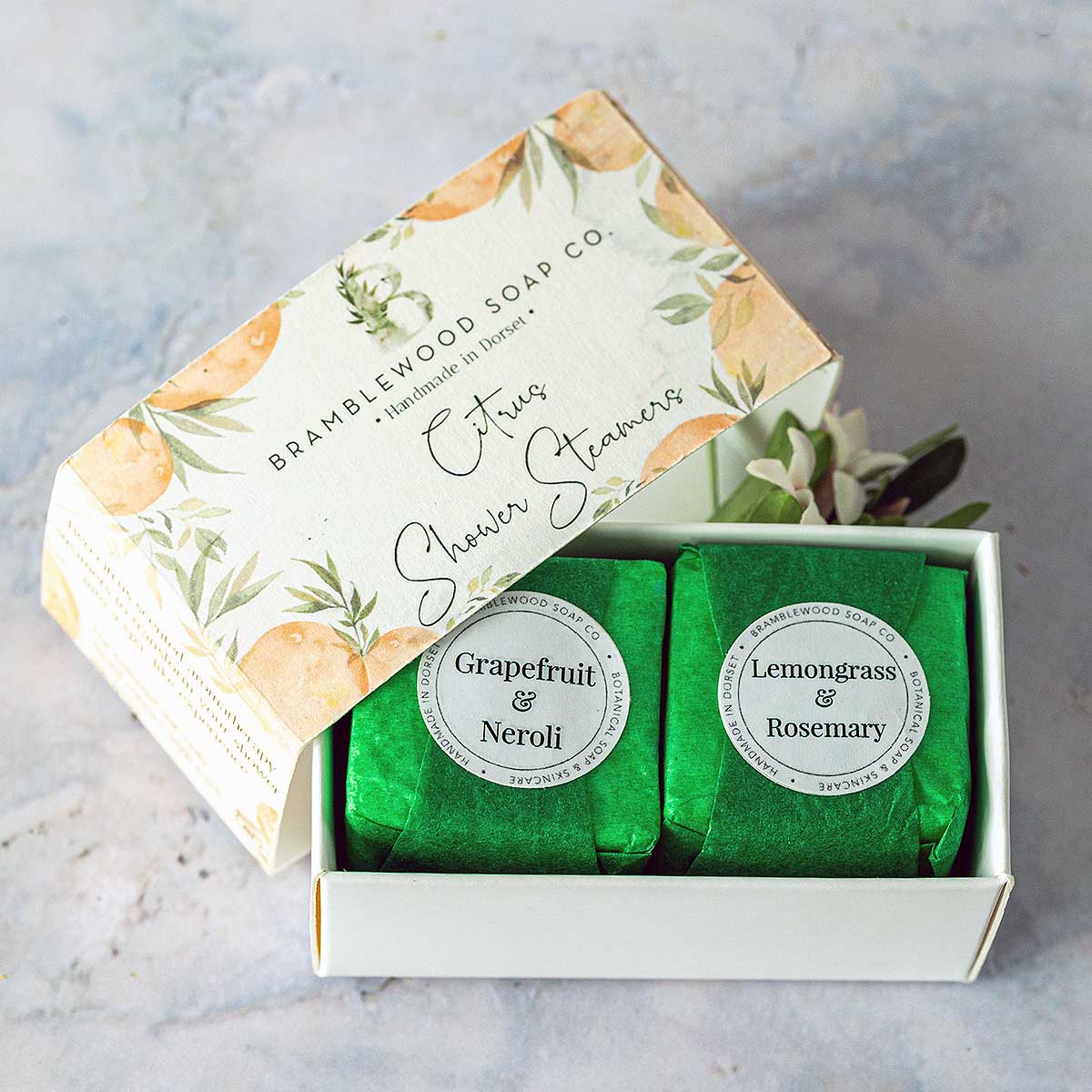 Citrus_shower_steamers_wrapped two wrapped shower cubes in a box