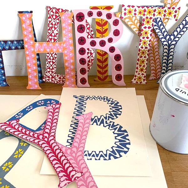 colourful happy birthday letters in different designs on a table