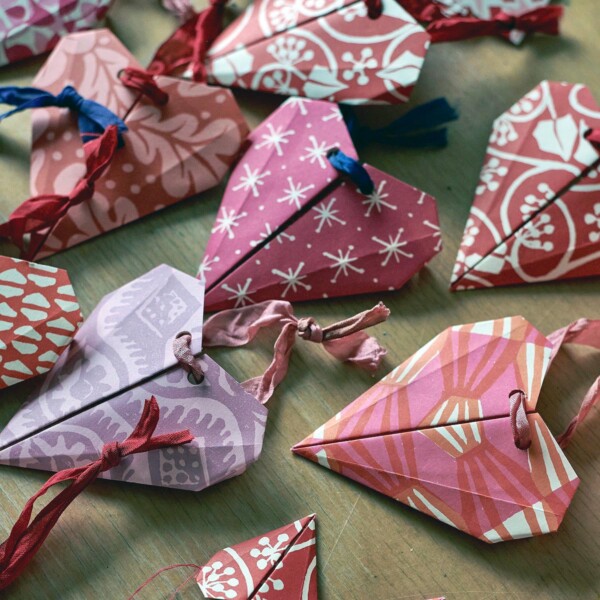 various made up pink and red origami hearts on a table