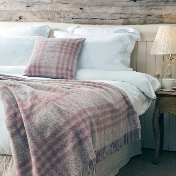 pink check throw on a large bed