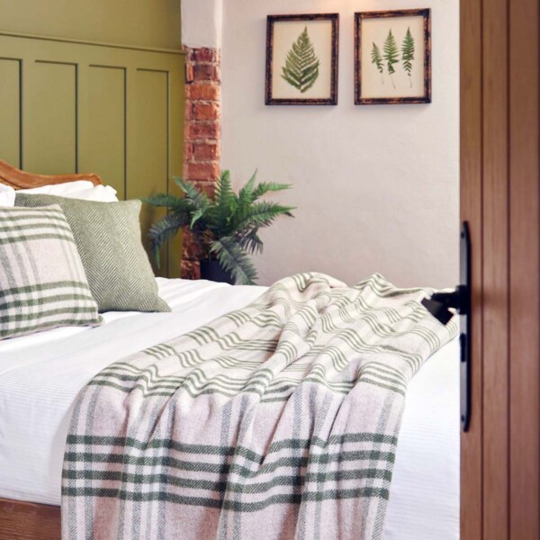 green check throw over a large bed
