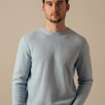 man wearing jumper on a neutral background