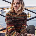 woman wearing a fair isle jumper with a harbour view behind