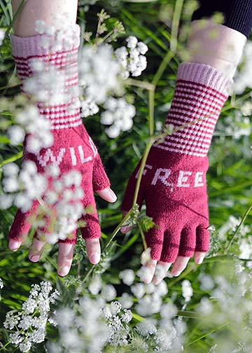 mittens worn on hands amongst white flowers
