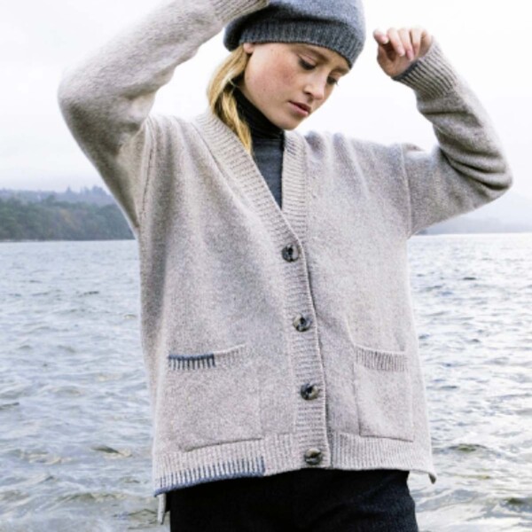 girl wearing cardigan in a lakeside setting