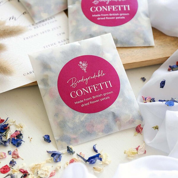 packets of confetti on white cloth with loose confetti