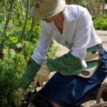 woman kneeling on kneeler gardening