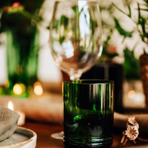 green tumbler on a laid dining table