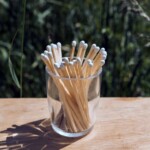 glass pot with matches on table outdoors
