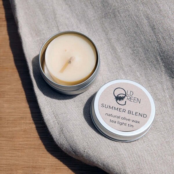 open tea light tin on cloth on table