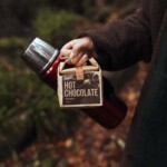 view of packet and flask being carried through an autumn wood