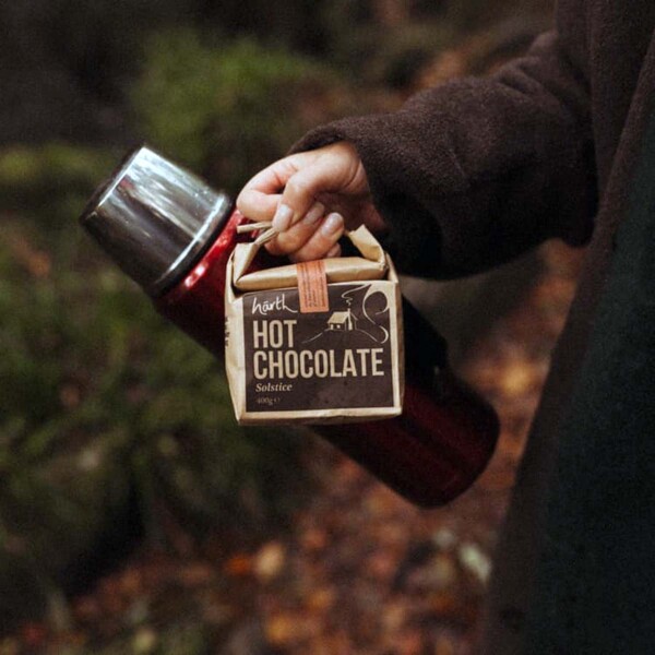 view of packet and flask being carried through an autumn wood